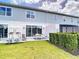View of the home's backyard showing grass lawn and patio with table and chairs at 812 Driving Range Ct, Reunion, FL 34747
