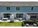 Backyard view of townhouse with sliding glass doors and patio set for outdoor dining at 812 Driving Range Ct, Reunion, FL 34747