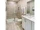 Clean bathroom with a modern vanity, a large mirror, and a glass-enclosed shower with tile surround at 812 Driving Range Ct, Reunion, FL 34747