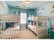 Playful bedroom with two bunk beds, marine-themed decor, and natural light from the window at 812 Driving Range Ct, Reunion, FL 34747