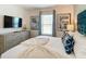 Serene bedroom featuring a comfortable bed with a stylish headboard and soft bedding, complemented by neutral decor at 812 Driving Range Ct, Reunion, FL 34747