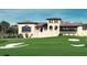 Exterior view of clubhouse with golf course in foreground featuring well manicured grounds at 812 Driving Range Ct, Reunion, FL 34747