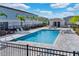 Resort-style pool with lounge chairs surrounded by well-maintained landscaping and palm trees at 812 Driving Range Ct, Reunion, FL 34747