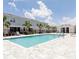 Community pool with a pool house, lounge chairs and pristine landscaping at 812 Driving Range Ct, Reunion, FL 34747