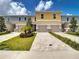 Beautiful townhome with a paver driveway, a two-car garage, and manicured landscaping at 812 Driving Range Ct, Reunion, FL 34747