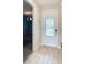 Bright foyer with a white front door with glass insert and light wood floors at 812 Driving Range Ct, Reunion, FL 34747