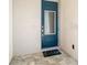 Stylish blue front door features a glass insert and a welcoming 'hello' doormat at 812 Driving Range Ct, Reunion, FL 34747