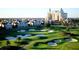 Scenic view of a pristine golf course surrounded by well-manicured landscaping and residential properties at 812 Driving Range Ct, Reunion, FL 34747