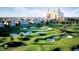Scenic view of a luxury golf course with water features, manicured greens, and resort buildings in the background at 812 Driving Range Ct, Reunion, FL 34747