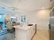 Contemporary kitchen featuring quartz countertops, an island with seating, and stainless appliances at 812 Driving Range Ct, Reunion, FL 34747