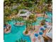 Aerial view featuring a lazy river winding through palm trees and recreational areas at 812 Driving Range Ct, Reunion, FL 34747
