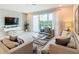 Bright living room with a large sliding glass door to the outdoor area, featuring a cozy sofa and modern decor at 812 Driving Range Ct, Reunion, FL 34747