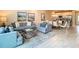 Open-concept living room with modern furnishings and decor, flowing seamlessly into the kitchen and dining areas at 812 Driving Range Ct, Reunion, FL 34747