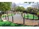 An outdoor view of a well-maintained mini golf course with manicured landscape and pebble lined walking path at 812 Driving Range Ct, Reunion, FL 34747