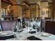 Beautiful restaurant dining room with luxurious decor featuring stone columns, archways and ample seating at 812 Driving Range Ct, Reunion, FL 34747