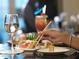 Delicious sushi with a glass of wine at a beautifully set table in a restaurant at 812 Driving Range Ct, Reunion, FL 34747