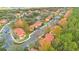Aerial view of residential neighborhood, showcasing tree-lined streets and community layout at 8447 Crystal Cove Loop # 8447, Kissimmee, FL 34747