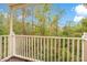 Balcony features white railings and views of the property's beautiful green natural surroundings at 8447 Crystal Cove Loop # 8447, Kissimmee, FL 34747