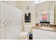 Bathroom featuring a shower with patterned curtains, a toilet, and a sink with granite countertops at 8447 Crystal Cove Loop # 8447, Kissimmee, FL 34747