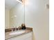 Bathroom features a modern sink with granite counters, a large mirror, and ample lighting at 8447 Crystal Cove Loop # 8447, Kissimmee, FL 34747