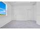 A spacious, carpeted bedroom with two closets and a large window at 8447 Crystal Cove Loop # 8447, Kissimmee, FL 34747