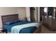 Bedroom featuring wood-look furniture, plush bedding, and a convenient closet for ample storage at 8447 Crystal Cove Loop # 8447, Kissimmee, FL 34747