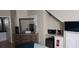Bedroom with wood dresser and mirror, TV, mini fridge and microwave for convenient and comfortable living at 8447 Crystal Cove Loop # 8447, Kissimmee, FL 34747
