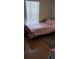 Cozy bedroom with a twin bed, pink sheets, and bright window light at 8447 Crystal Cove Loop # 8447, Kissimmee, FL 34747
