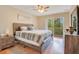 Cozy bedroom features a ceiling fan and a sliding glass door to private balcony at 8447 Crystal Cove Loop # 8447, Kissimmee, FL 34747
