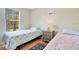 Bright bedroom with two single beds, wood floors and a large sunlit window at 8447 Crystal Cove Loop # 8447, Kissimmee, FL 34747