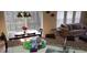 Bright dining area with sliding glass doors, dark wood table, and modern lighting fixture, and partial living room view at 8447 Crystal Cove Loop # 8447, Kissimmee, FL 34747