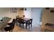 View of dining area with dark wood table and 6 chairs, next to breakfast bar and sliding glass doors to the exterior at 8447 Crystal Cove Loop # 8447, Kissimmee, FL 34747
