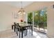 Bright dining area featuring sliding glass doors to the patio and a modern chandelier at 8447 Crystal Cove Loop # 8447, Kissimmee, FL 34747