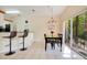 Cozy dining area with modern chandelier and sliding glass doors to backyard at 8447 Crystal Cove Loop # 8447, Kissimmee, FL 34747