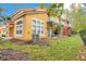 Charming multi-level townhouse boasts a bright yellow exterior and a private balcony at 8447 Crystal Cove Loop # 8447, Kissimmee, FL 34747