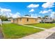 Cozy yellow home with a spacious green lawn and a classic, clean design at 8447 Crystal Cove Loop # 8447, Kissimmee, FL 34747
