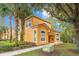 Inviting two-story home featuring a well-manicured lawn and bright, freshly painted exterior at 8447 Crystal Cove Loop # 8447, Kissimmee, FL 34747