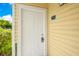 Classic white front door with a welcome-home vibe, enhanced by natural sunlight at 8447 Crystal Cove Loop # 8447, Kissimmee, FL 34747