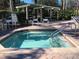 Relaxing community hot tub area with pergola and lounge chairs at 8447 Crystal Cove Loop # 8447, Kissimmee, FL 34747