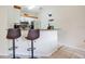 A modern kitchen featuring a breakfast bar with two chairs, granite countertops and stainless steel appliances at 8447 Crystal Cove Loop # 8447, Kissimmee, FL 34747