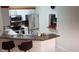 Kitchen featuring stainless steel appliances, white cabinetry and granite countertops with stainless steel sink and breakfast bar at 8447 Crystal Cove Loop # 8447, Kissimmee, FL 34747