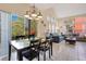 Open concept living space featuring dining table, tile flooring, bright lighting, and comfortable seating at 8447 Crystal Cove Loop # 8447, Kissimmee, FL 34747