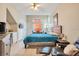 This main bedroom features a bed with a blue cover, high ceilings, walk-in closet, and tile flooring at 8447 Crystal Cove Loop # 8447, Kissimmee, FL 34747