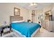 This main bedroom features a bed with a blue cover, walk-in closet, and tile flooring at 8447 Crystal Cove Loop # 8447, Kissimmee, FL 34747