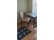 Home office featuring a neutral chair, wooden desk with black metal legs, and a large window at 8447 Crystal Cove Loop # 8447, Kissimmee, FL 34747