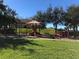 Well-maintained community playground with slide, swings, and dome climber at 8447 Crystal Cove Loop # 8447, Kissimmee, FL 34747