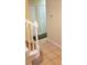 Staircase featuring white wooden banisters, light colored walls, and warm wood grain steps and tile entryway at 8447 Crystal Cove Loop # 8447, Kissimmee, FL 34747