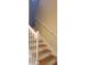Staircase features white wooden banisters, light colored walls, and warm wood grain steps and trim at 8447 Crystal Cove Loop # 8447, Kissimmee, FL 34747