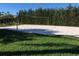 Well-maintained sand volleyball court surrounded by lush green grass and tall hedges at 8447 Crystal Cove Loop # 8447, Kissimmee, FL 34747