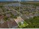 Aerial view showcases the property's proximity to a serene lake and the layout of the neighborhood at 8676 Currituck Sound Ln, Orlando, FL 32829